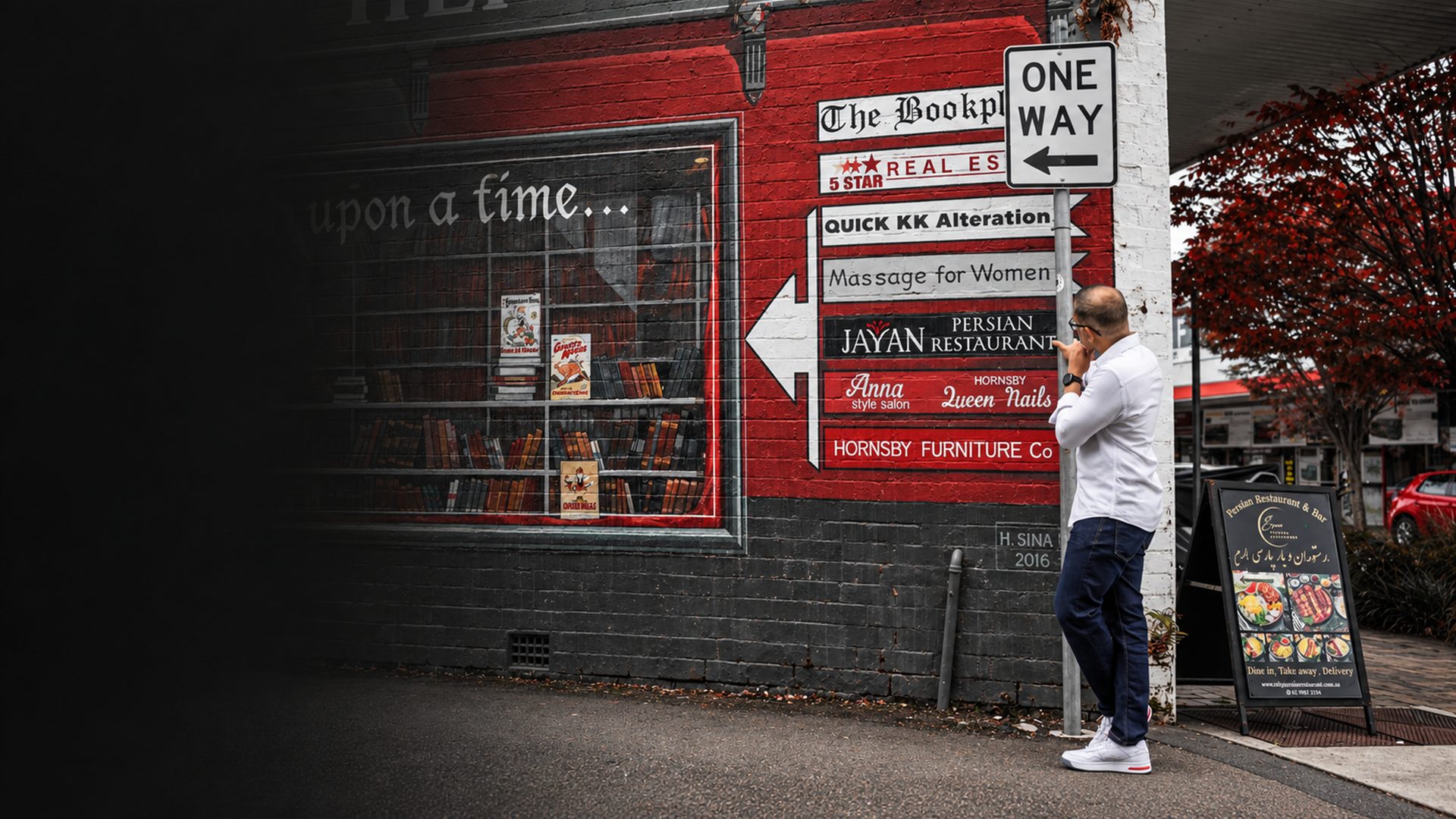 Man pausing thoughtfully outside local Hornsby shopfronts