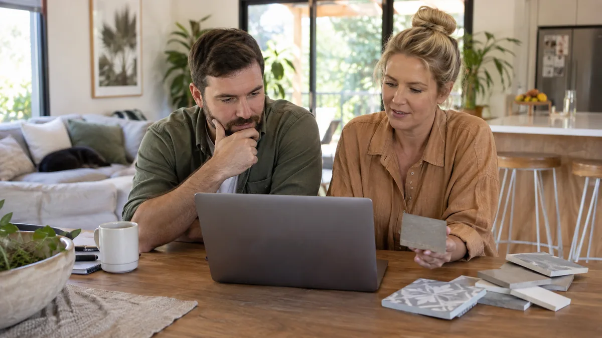 Marketer reviewing a conversion funnel diagram with drop-off percentages on a laptop screen.